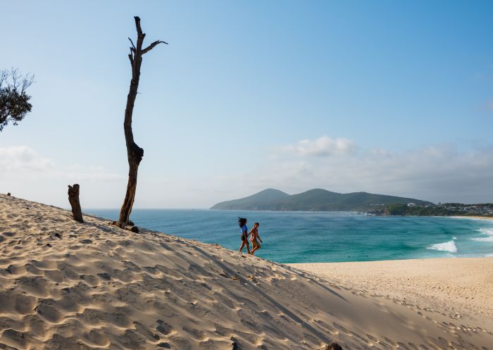 Couple walking down sand dune, One Mile Sand Dune, Forster