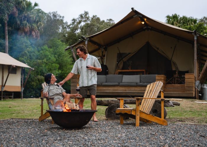 Couple around campfire, Myall River Camp, Hawkes Nest