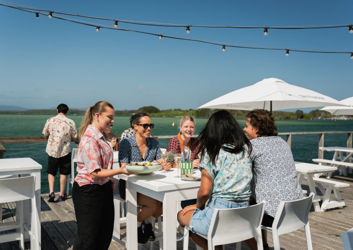 Guests on deck enjoying food, Thirty Three Degrees, Tuncurry