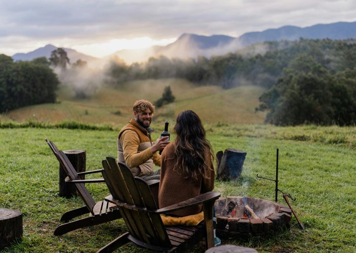 Couple around firepit, Into The Wild Escapes - Tiny Nancy, Bellingen - Credit: Into The Wild Escapes