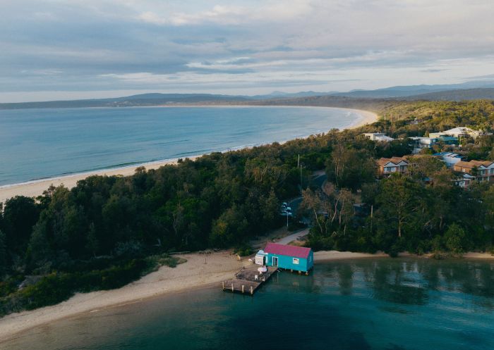 Aerial over Mitchies Jetty and Cafe on the foreshore of Merimbula Lake, Mitchie's Jetty and Cafe, Merimbula