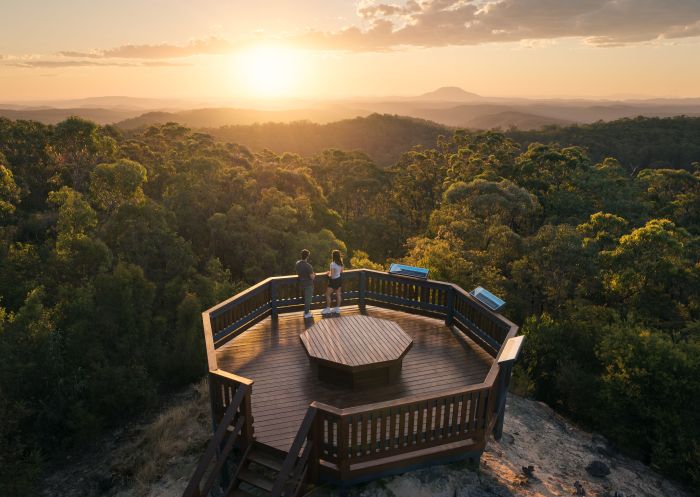 Couple enjoying the sunset and views, Finchley Lookout, Yengo National Park