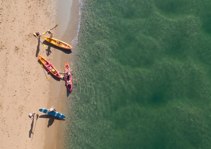Aerial view of kayaks and stand-up paddle-boarding on shoreline, C-Change Adventures, Coffs Harbour