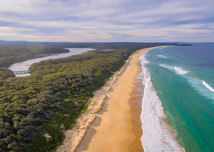 Aerial view of long sand beach with river, Wairo Beach - Credit: Andy Hutchinson