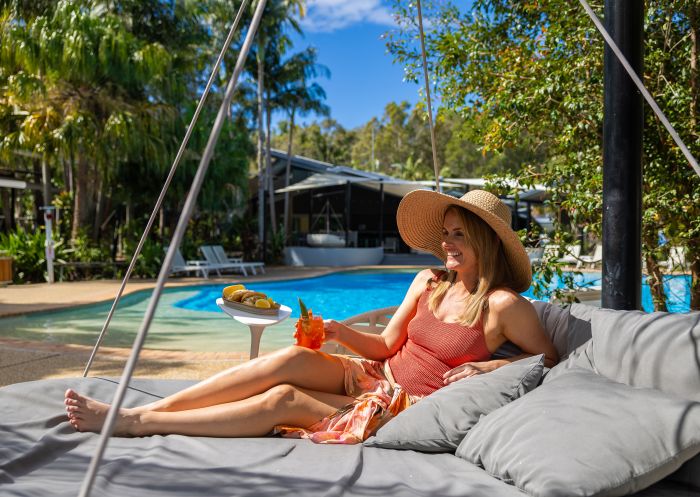Woman by pool with Aperol, NRMA Angourie Resort Yamba, Yamba - Credit: NRMA Angourie Resort Yamba