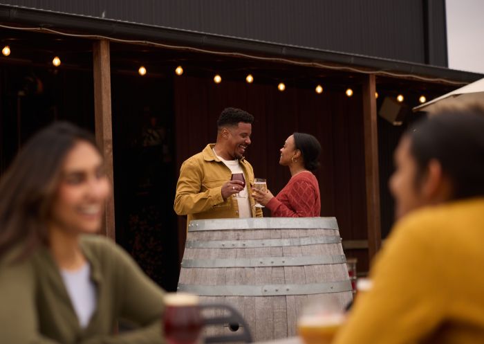 Couple drinking beer on a keg, Small Batch Brewery, Mudgee