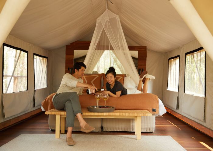 Couple enjoying a romantic glamping getaway, Paperbark Camp, Woollamia
