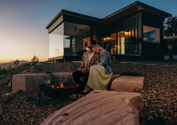 Couple sitting outside of cabin, Sierra Escape Luxury Glamping, Mudgee - Credit: Sierra Escape