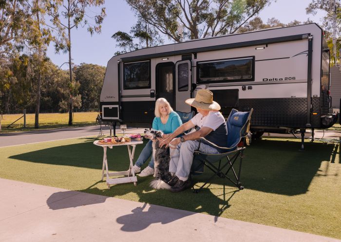 Couple with dog in front of caravan, Reflections Bonny Hills - Holiday Park, Bonny Hills - Credit: Reflections Bonny Hills - Holiday Park