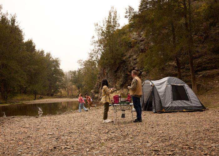 Family camping along the river at Crossley Bridge Sofala Campsite, Sofala