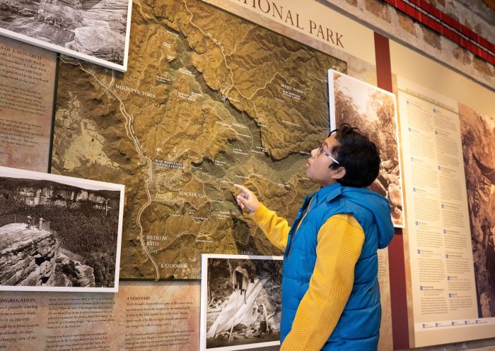 Child looking at a map at the Blue Mountains Heritage Centre, Blackheath