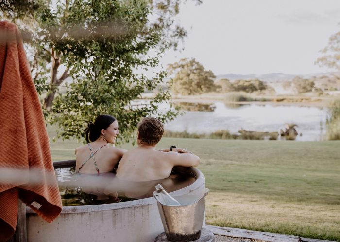 Couple in hot tub looking out into the country scenery at Evamor Valley, Mudgee - Credit: Stephaine Halpin