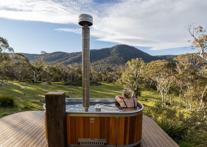 Outdoor bath with view of mountain scenery at Crafters Cabins, Crackenback - Credit: Crafters Cabins