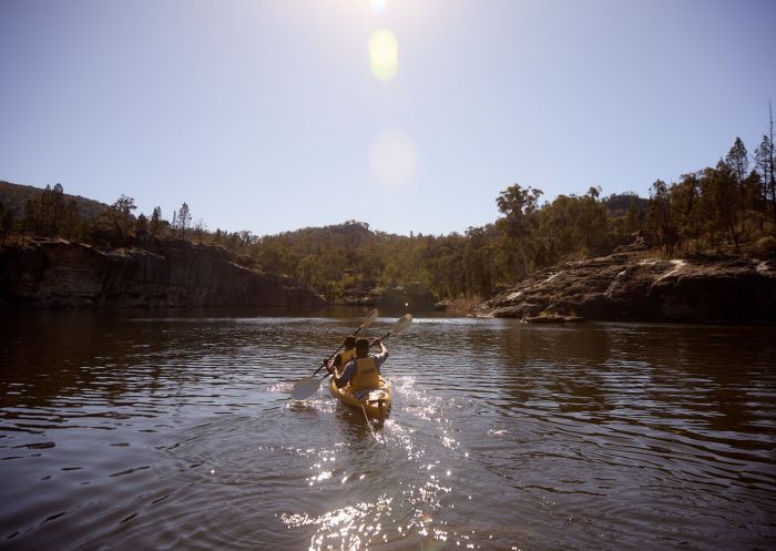 Couple enjoying a kayaking adventure along a river in Wollemi National Park