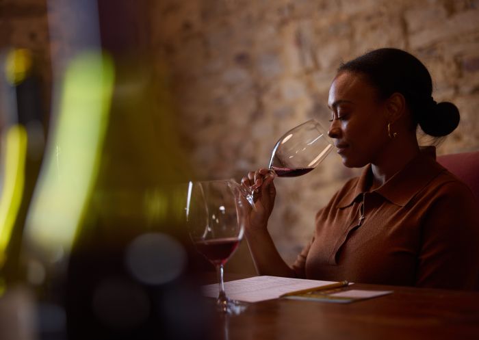 A lady enjoying a wine tasting at De Beaurepaire Wines, Rylstone