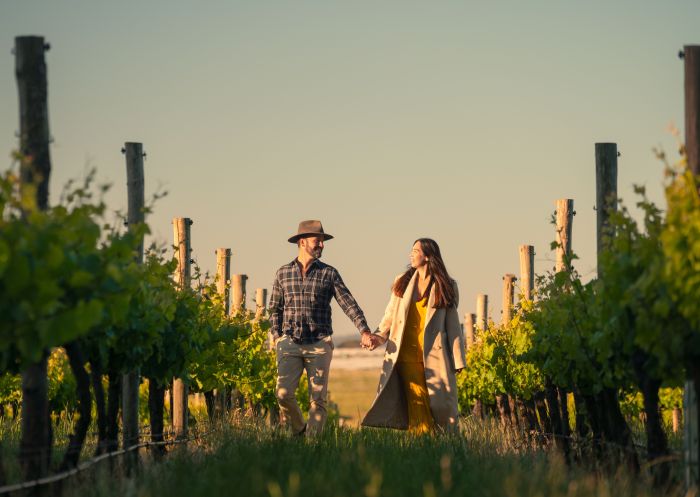 Couple walking through the vineyards at Ross Hill Wines, Orange