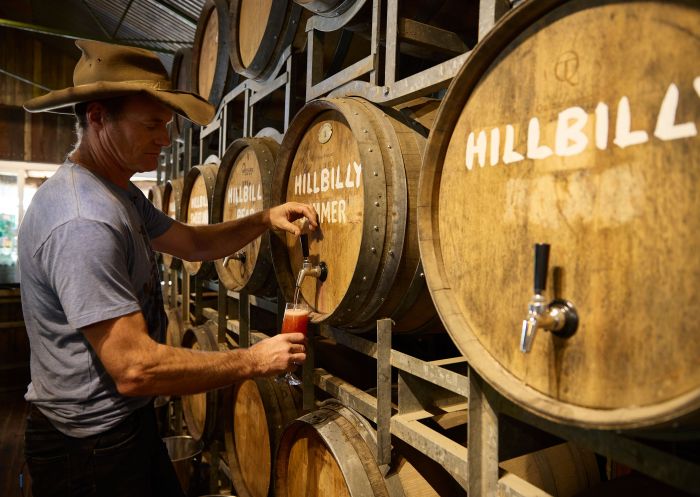Hillbilly Cider owner Shane McLoughlin pouring ciders for tasting at Hillbilly Cider, Bilpin
