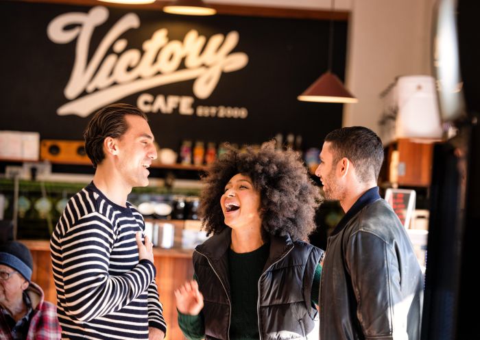 Friends laughing and chatting in Victory Cafe, Blackheath