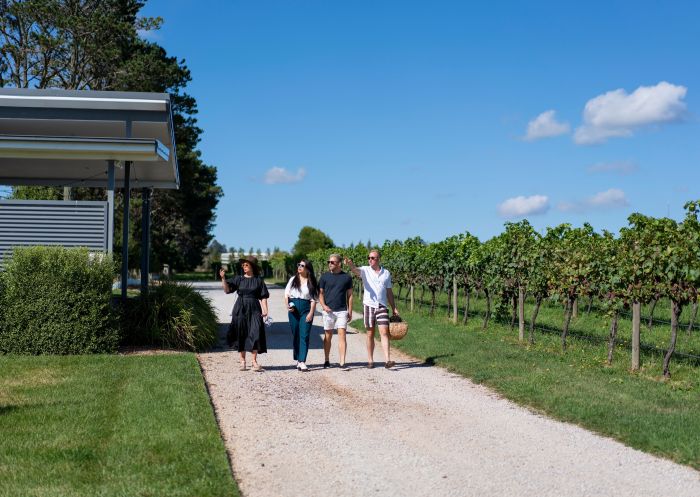 Friends walking along a footpath in the vineyard at Rowlee Wines & Guesthouse, Orange