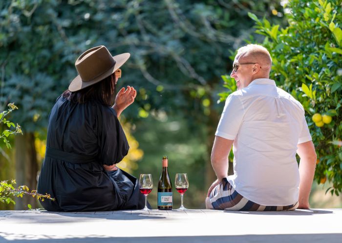A couple of friends having a chat and sharing a bottle of handcrafted wine at Rowlee Wines & Guesthouse, Orange