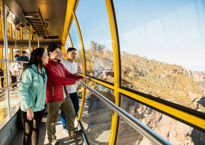 Young people enjoying the views of the Blue Mountains from the Skyway at Scenic World, Katoomba
