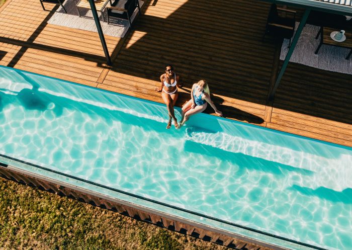 Aerial view of friends sitting by the edge of the pool in the sun at Sierra Escape, Mudgee - Credit: Sierra Escape