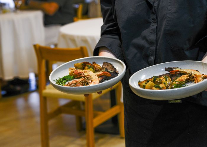 Waiter holding two plates, Mirritya Mundya Restaurant, Culburra Beach - Credit: Mirritya Mundya Restaurant
