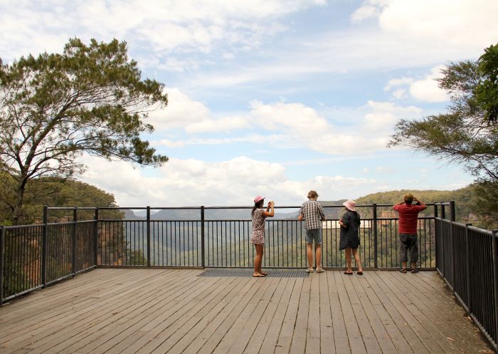 People taking photos of the scenic landscape from Fitzroy Falls Lookout, Fitzroy Falls - Credit: John Yurasek | DCCEEW