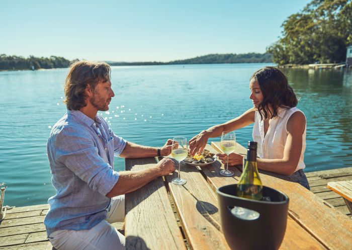 Couple enjoying fresh oysters and wine, Tuross Boatshed & Cafe, Tuross Head