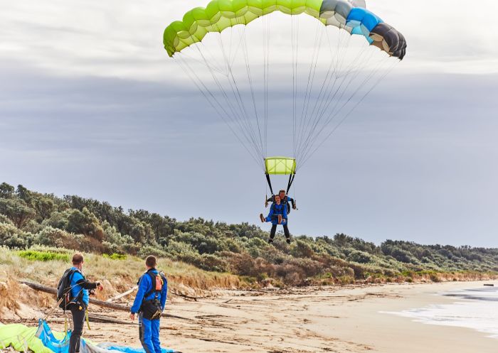 Tandem skydivers landing on the beach, Moruya