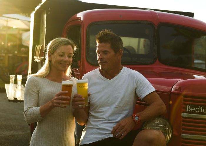 Couple enjoying a beer from Betty the Beer truck at Broulee Brewhouse, Broulee