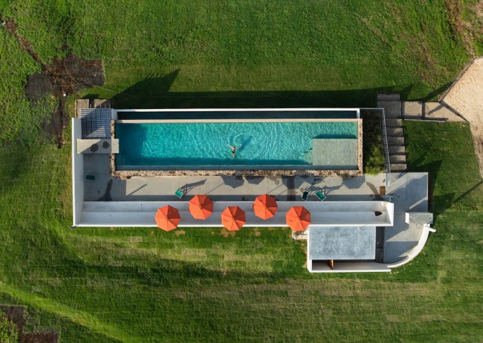 Woman enjoys a swim in the pool, Sun Ranch, Cooper's Shoot