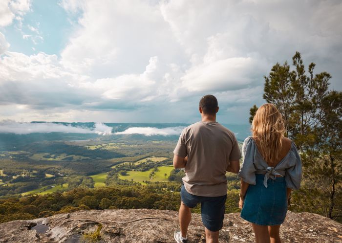 Couple enjoys the views along the Red Rocks trig walking track, which leads to scenic views across Kangaroo Valley and Morton National Park