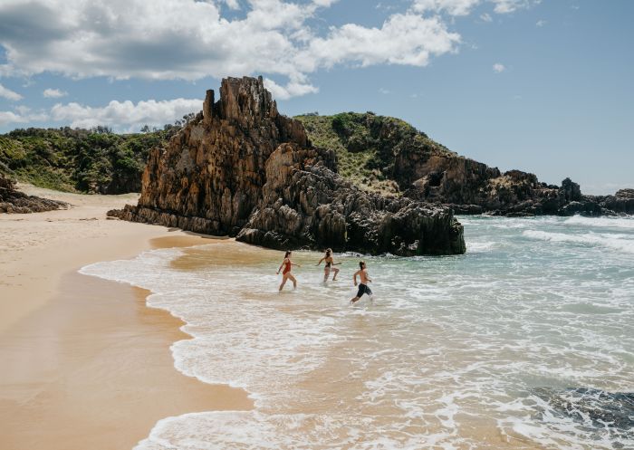 Three people running into water, Bingie Beach North, Bingie - Credit: Eurobodalla Coast Tourism