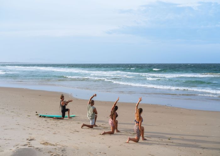 Friends stretching, Belongil Beach, Byron Bay