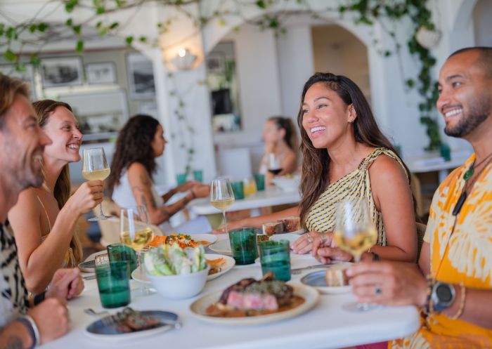 Friends enjoy a food and drink, Raes on Wategos, Byron Bay