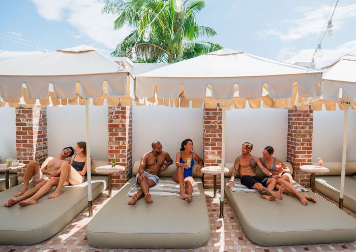 Friends enjoy drinks by the poolside, The Banya, Mullumbimby