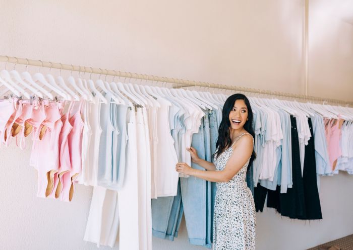 Woman shopping through clothes racks, Zulu and Zephyr, Byron Bay 