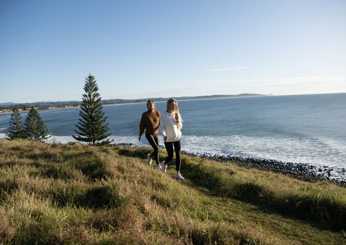 Friends walking across headland, Pat Morton Lookout, Lennox Head