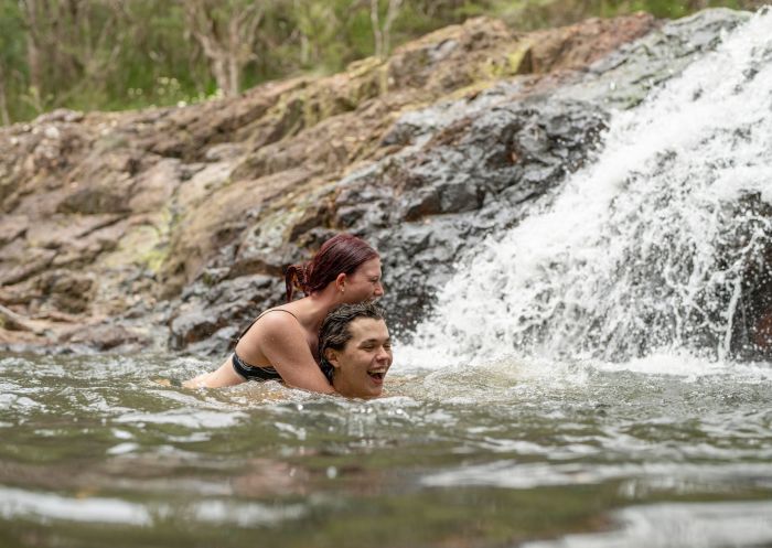 Couple swimming at waterfall pool, Minyon Falls Track, Nightcap National Park