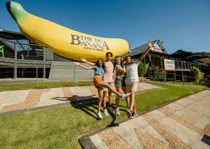 Young people posing in front of the Big Banana Fun Park, Coffs Harbour 