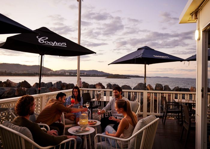 Friends enjoying balcony with drinks and food, Latitude 30, Coffs Harbour