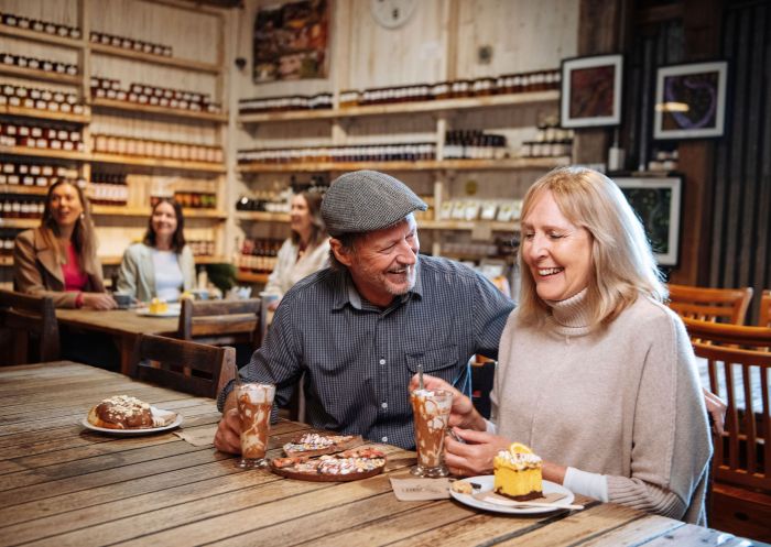 Couple having treats and cake, Junee Licorice and Chocolate, Junee