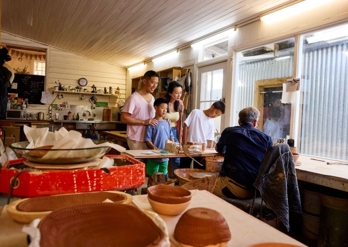 Couple watches on as local artist and potter Paul Bruce throws one-of-a-kind pieces in his pottery studio, Berrima Village Pottery, Berrima