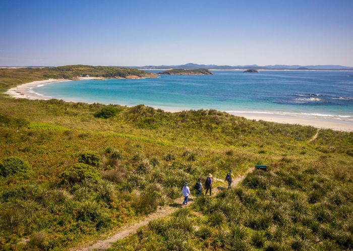 People walking along the walking track, Providence Beach, Broughton Island, Myall Lakes National Park - Credit: John Spencer | DCCEEW
