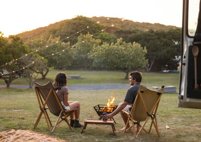 Couple at campfire, Flat Rock Tent Park, East Ballina - Credit: Ballina Shire Council