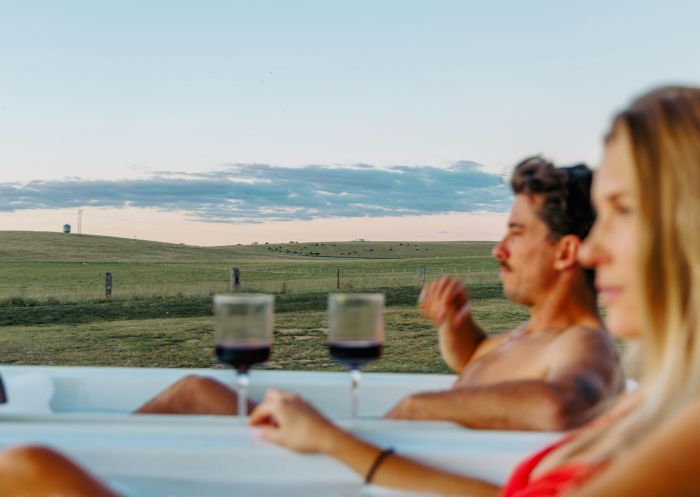 A couple enjoying a bath with wine in hand and paddock views at Rest at BoxGrove, Eglinton - Credit: BoxGrove Country Retreat