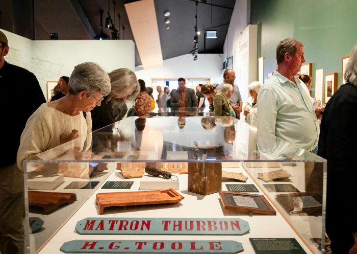 People viewing objects and photographs in the exhibition 'Bloomfield 1925-2025' at Orange Regional Museum, Orange - Credit: Orange Regional Museum