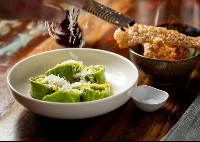 A white bowl with pasta and a smaller bowl with crackling at Bootleg Dining, Bathurst - Credit: Bathurst Visitor Information Centre