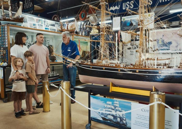 A volunteer giving a young family information about the museum, Ballina Naval and Maritime Museum, Ballina - Credit: Ballina Naval and Maritime Museum